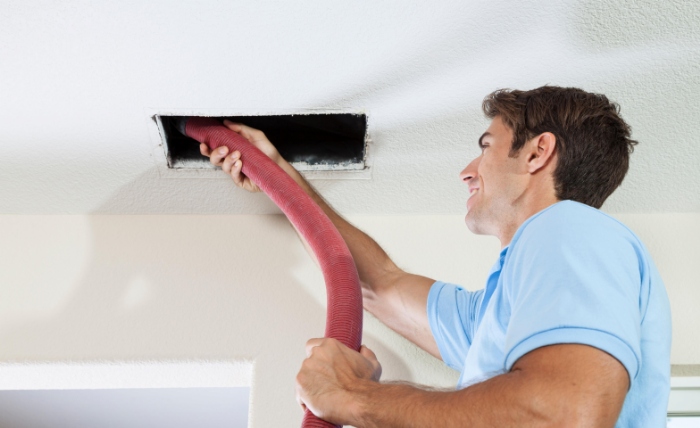 Man cleaning air ducts